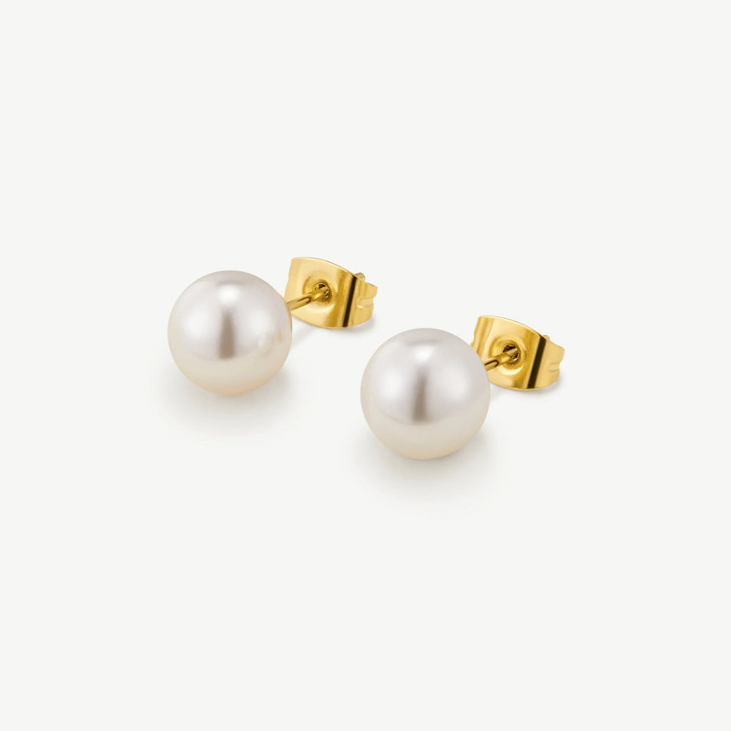Pair of elegant pearl stud earrings with gold posts on white background
