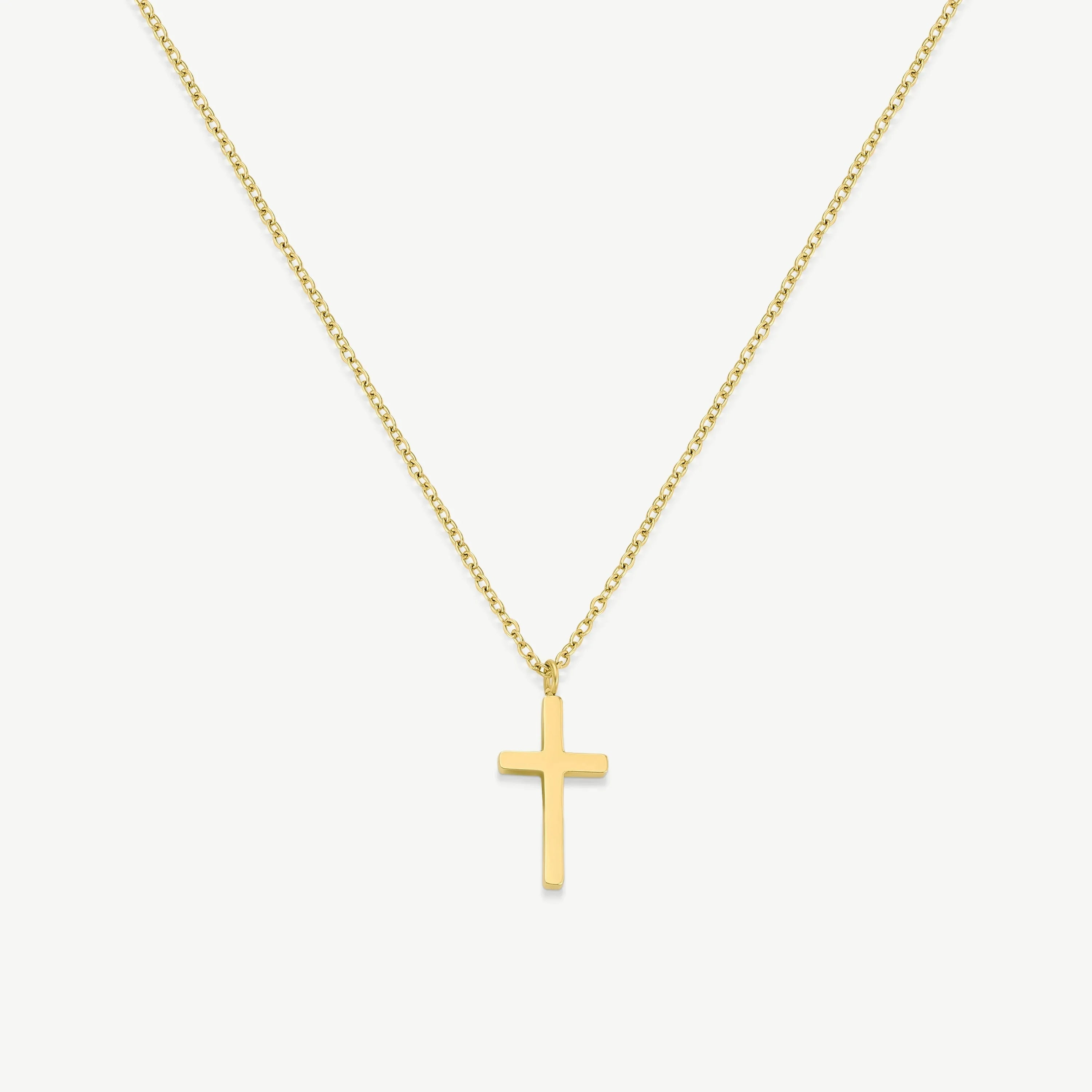 Minimalist gold cross pendant necklace on white background