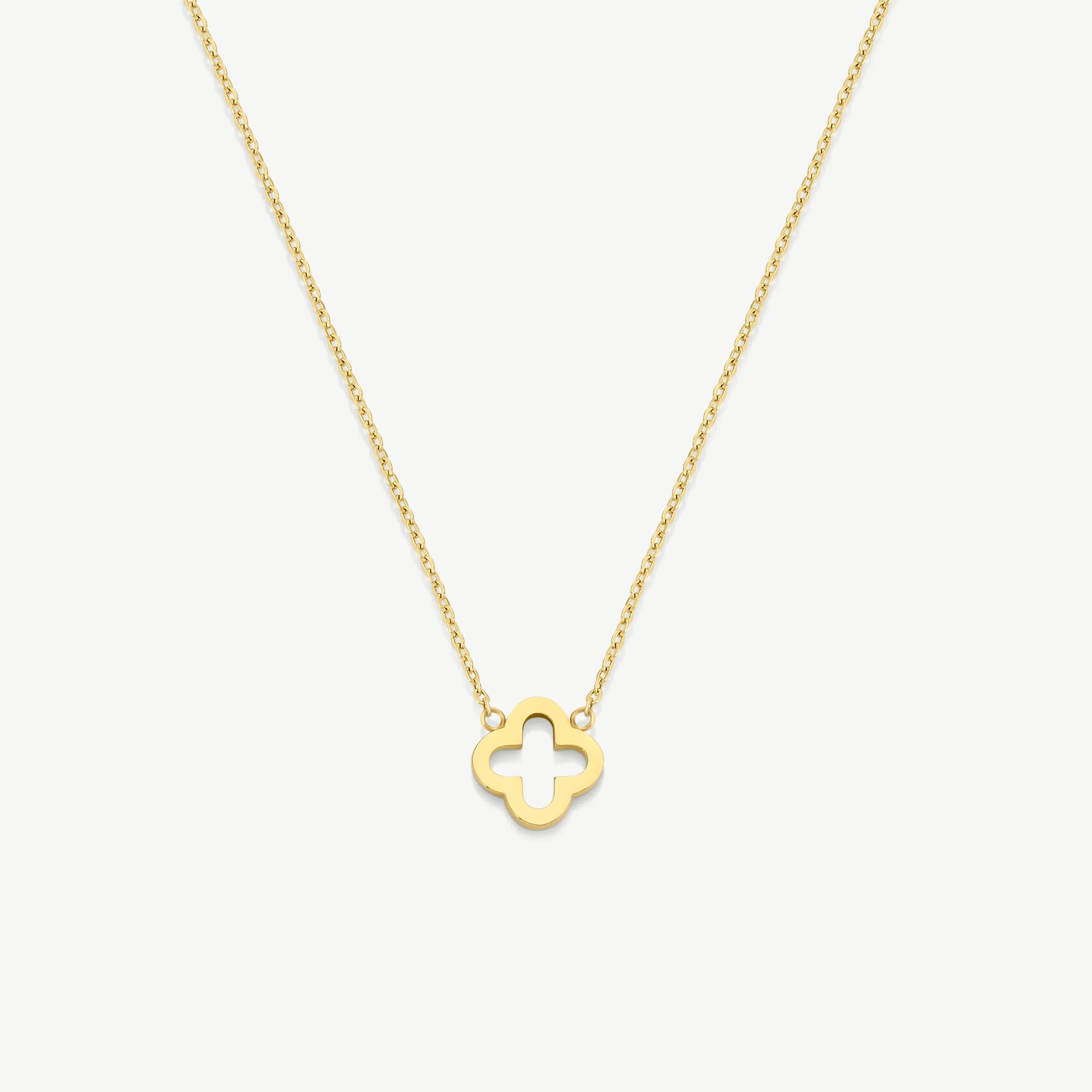 Gold necklace with hollow quatrefoil pendant on delicate chain, white background