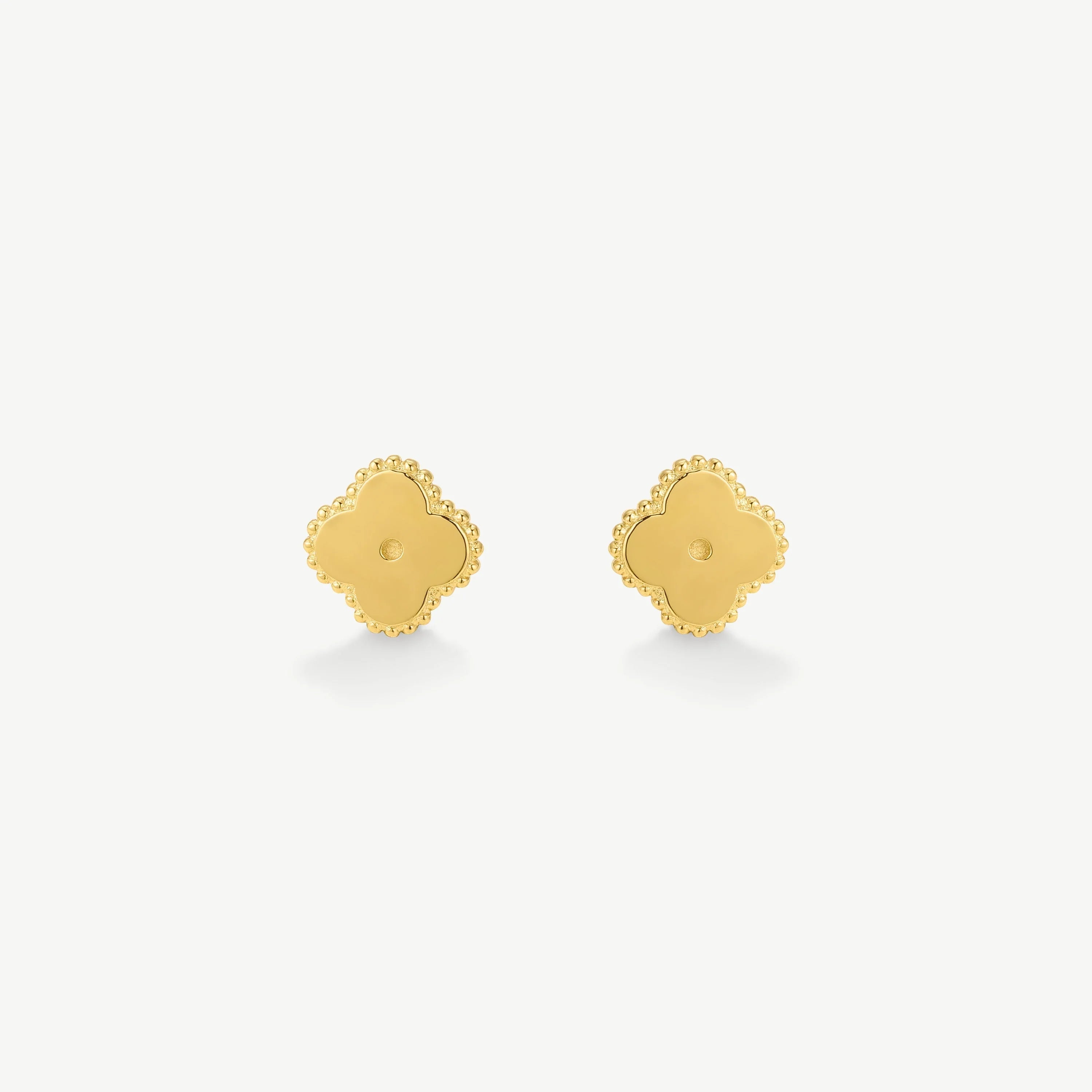 Pair of gold clover-shaped stud earrings with beaded edges on white background