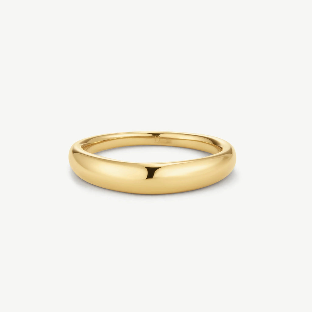 Polished gold dome-shaped ring on white background, sleek minimal jewelry