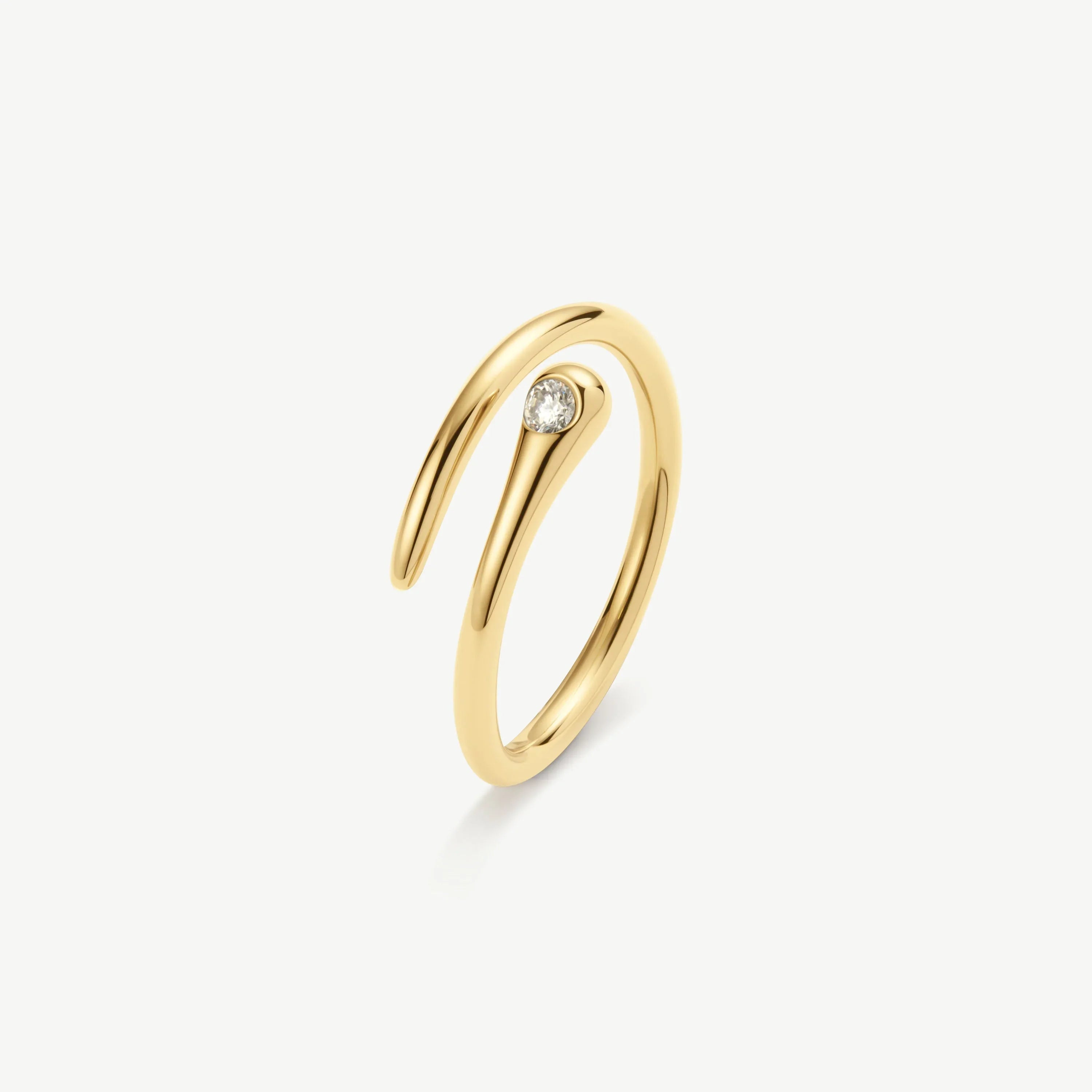 Minimalist 14K gold ring with small bezel-set round diamond on white background